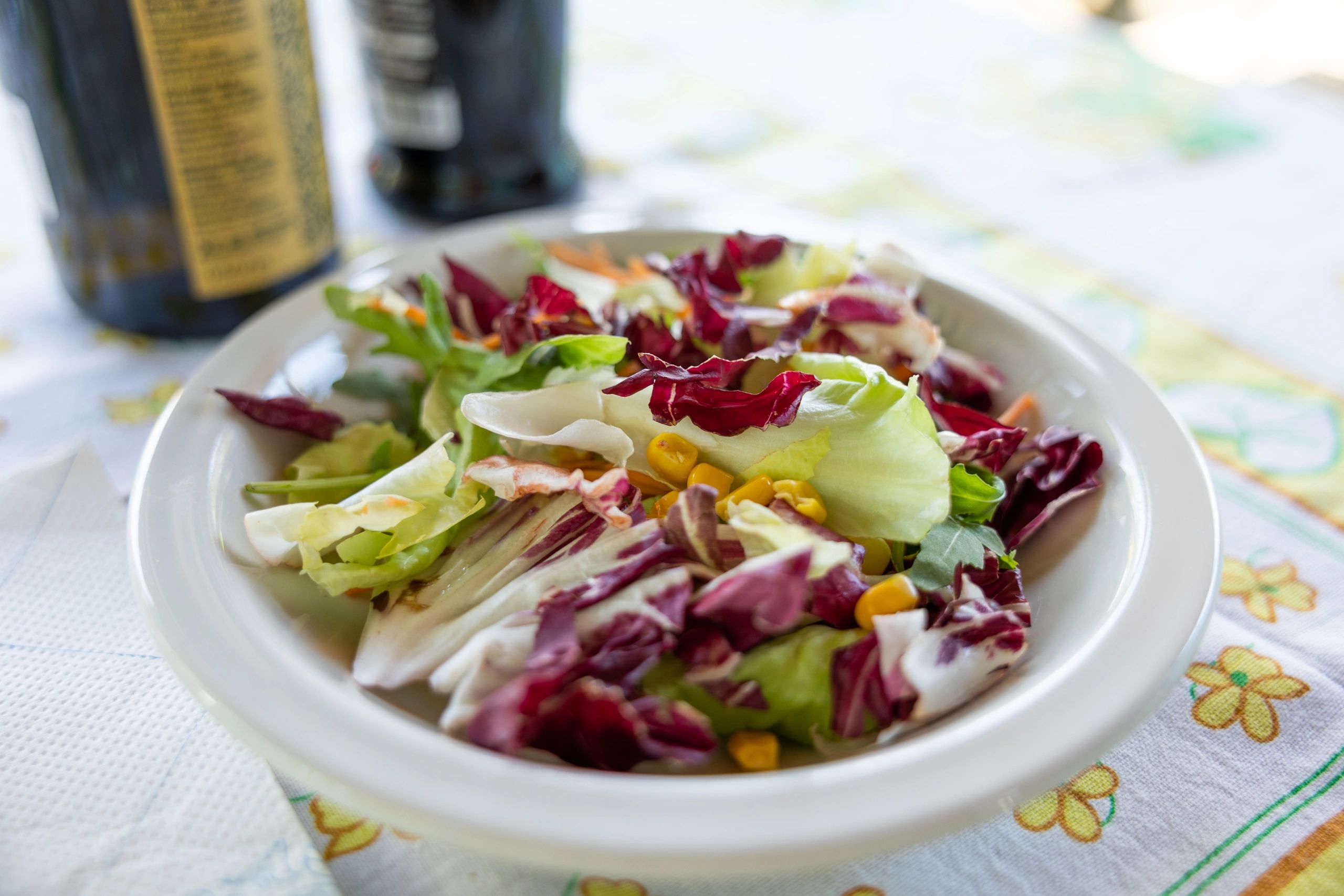 Fresh mixed salad and vegetables in a white bowl