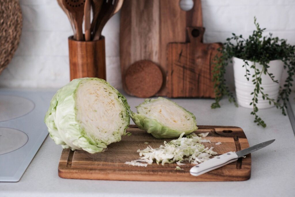 Fresh cabbage on a wooden board representing ingredients for kielbasa and sauerkraut