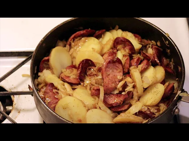 Traditional kielbasa sausage simmered with sauerkraut and potatoes in a hearty one-pot comfort food meal.